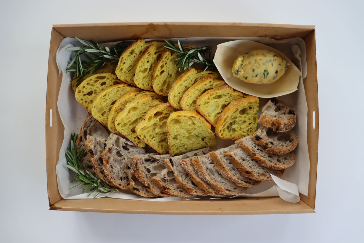 Volare bread selection with confit garlic and herb butter Eatery